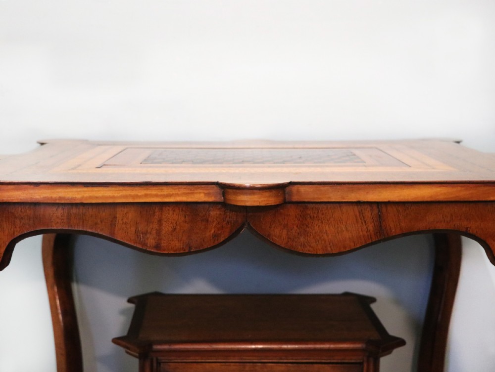 A late Victorian wooden occasional table featuring a geometric parquetry inlaid top, slender cabriole legs, and a lower glazed smokers cabinet. View XIV