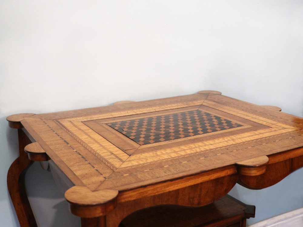 A late Victorian wooden occasional table featuring a geometric parquetry inlaid top, slender cabriole legs, and a lower glazed smokers cabinet. View XVIII