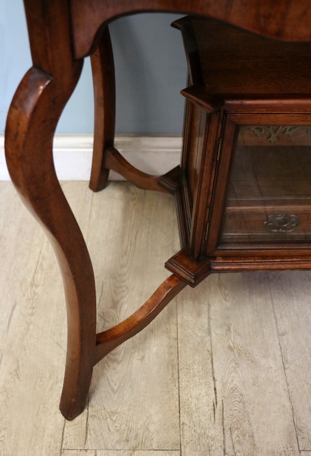 A late Victorian wooden occasional table featuring a geometric parquetry inlaid top, slender cabriole legs, and a lower glazed smokers cabinet. View XIX