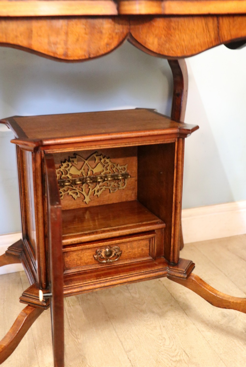 A late Victorian wooden occasional table featuring a geometric parquetry inlaid top, slender cabriole legs, and a lower glazed smokers cabinet. View XXIII