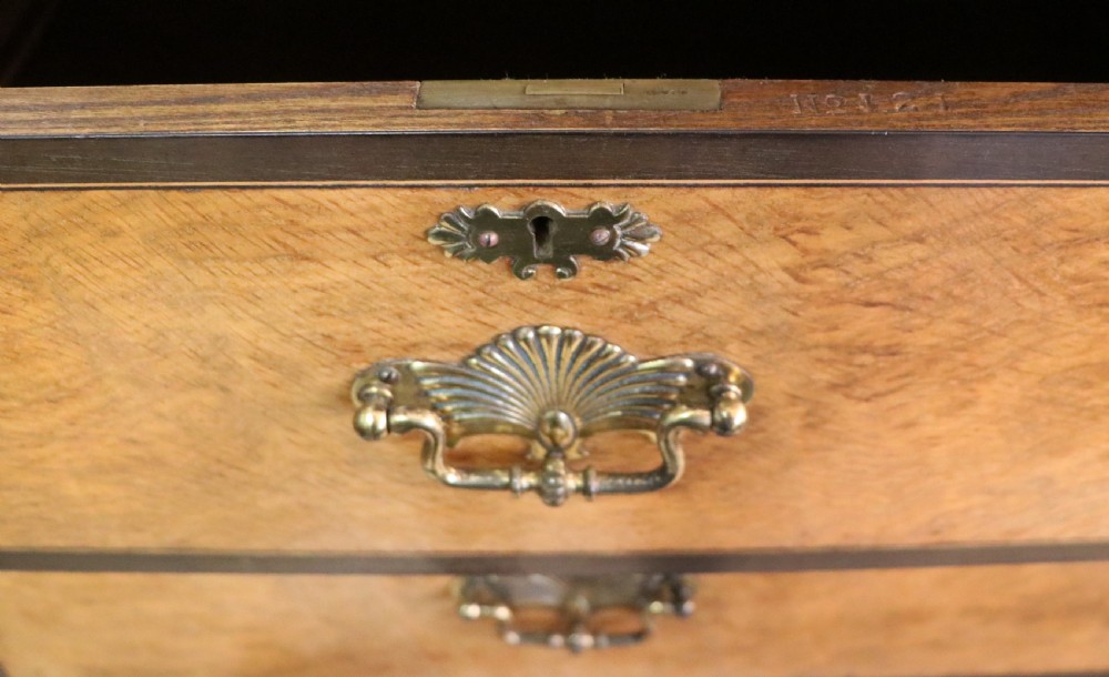 A late nineteenth-century American walnut compendium wardrobe featuring a full-length mirrored door, carved timber motif panel, open side shelving, brass handles, and integrated drawers. View XIX