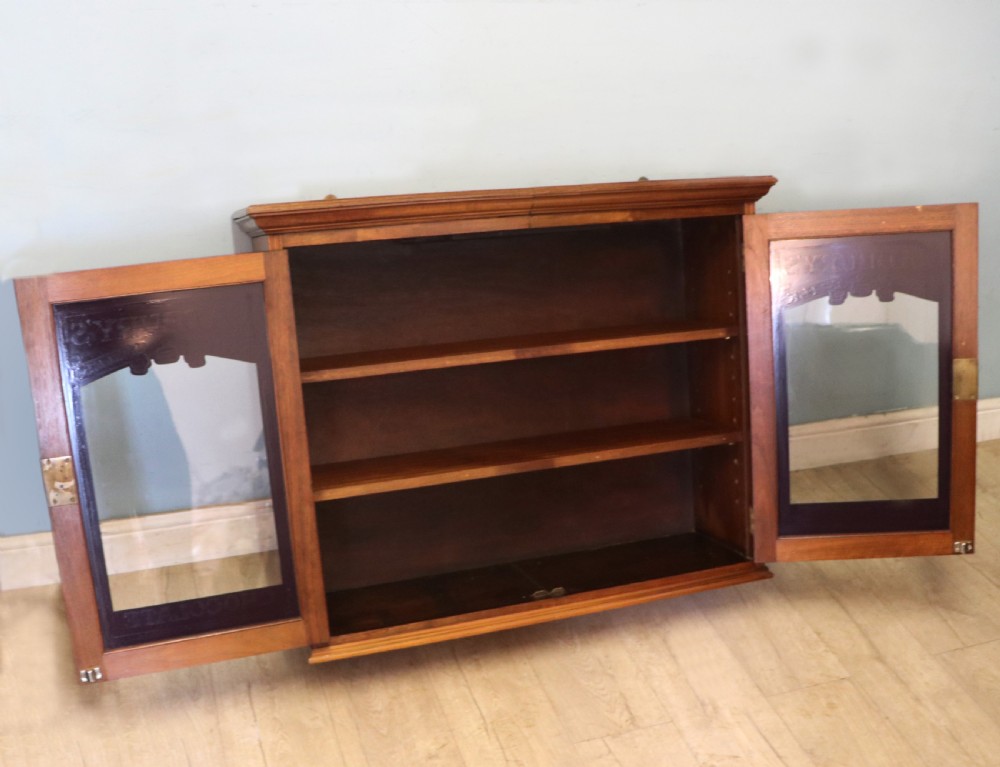 A superb late Victorian walnut framed wall cabinet, later sign written for Cadbury chocolate. View III