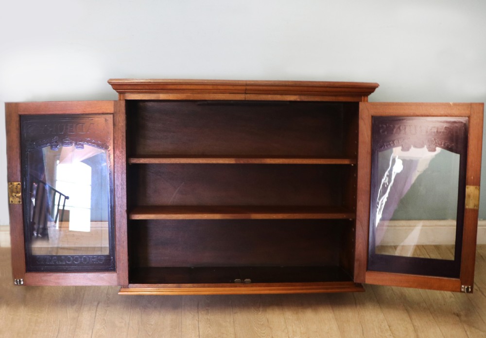A superb late Victorian walnut framed wall cabinet, later sign written for Cadbury chocolate. View V