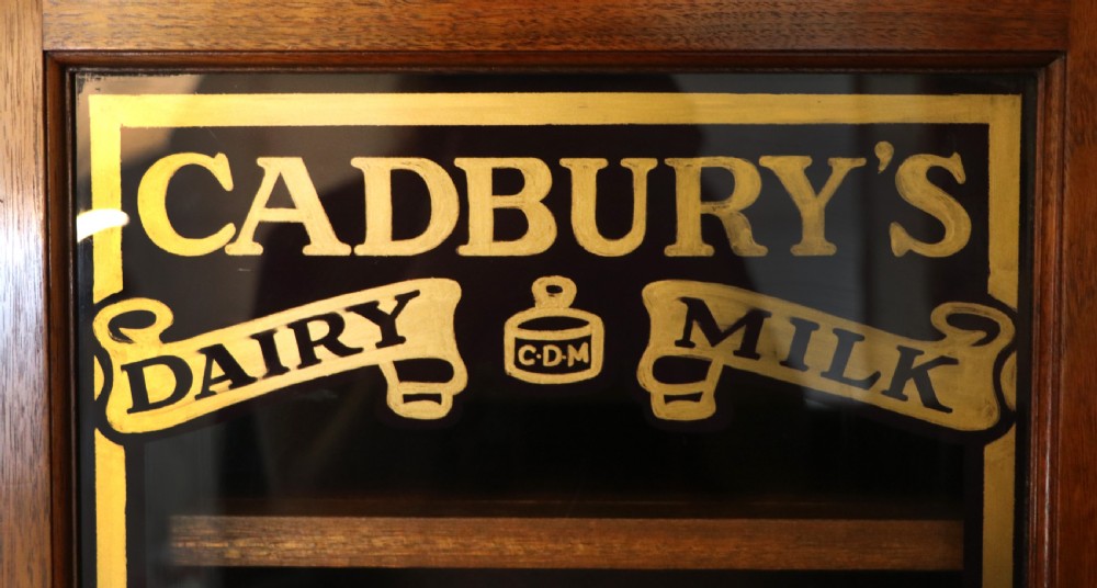 A superb late Victorian walnut framed wall cabinet, later sign written for Cadbury chocolate. View IX