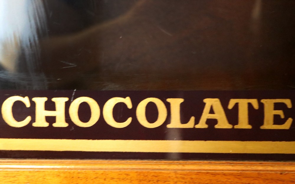 A superb late Victorian walnut framed wall cabinet, later sign written for Cadbury chocolate. View XIII