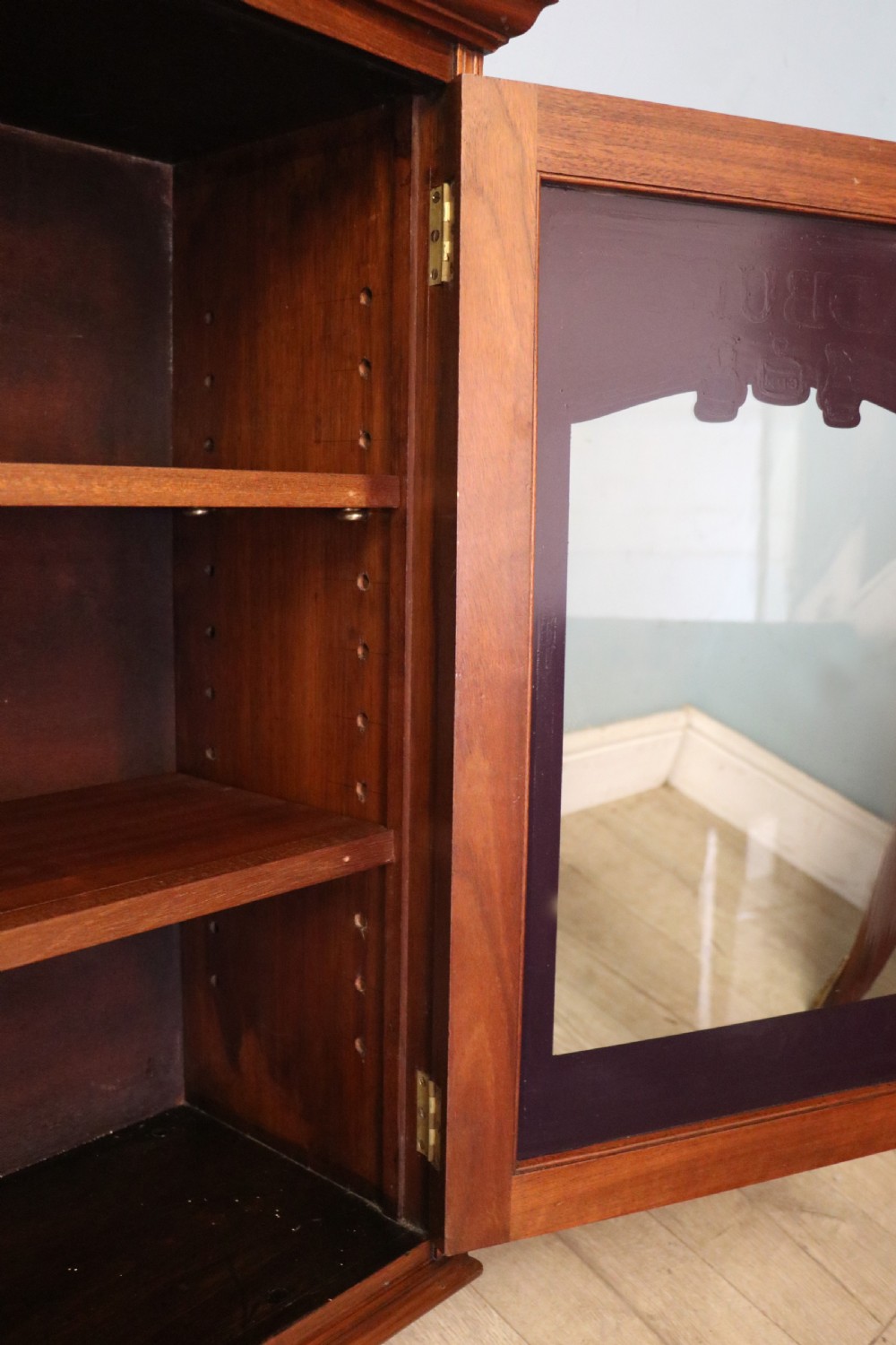 A superb late Victorian walnut framed wall cabinet, later sign written for Cadbury chocolate. View XX