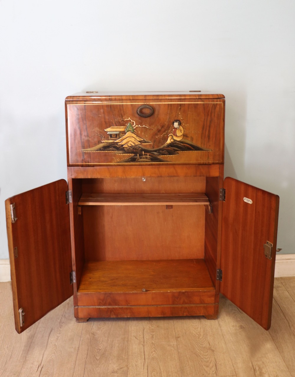A wonderfully stylish piece of retro furniture An Art Deco walnut and chinoiserie-decorated cabinet by Rivington.  View III