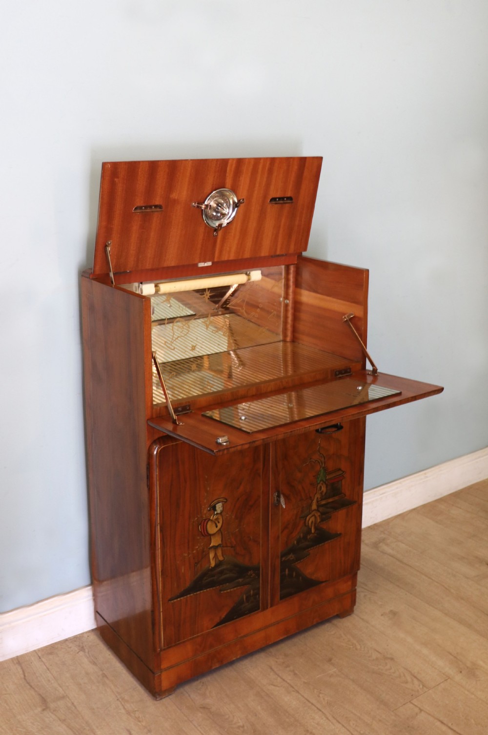 A wonderfully stylish piece of retro furniture An Art Deco walnut and chinoiserie-decorated cabinet by Rivington.  View IV