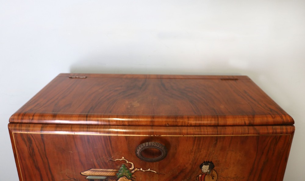 A wonderfully stylish piece of retro furniture An Art Deco walnut and chinoiserie-decorated cabinet by Rivington.  View VI