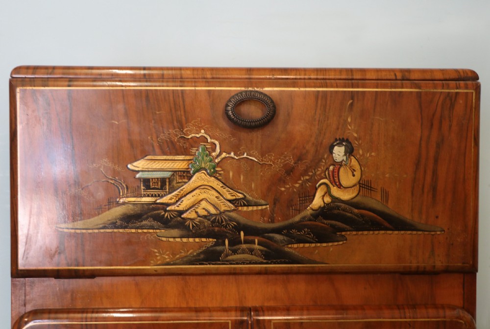 A wonderfully stylish piece of retro furniture An Art Deco walnut and chinoiserie-decorated cabinet by Rivington.  View VIII