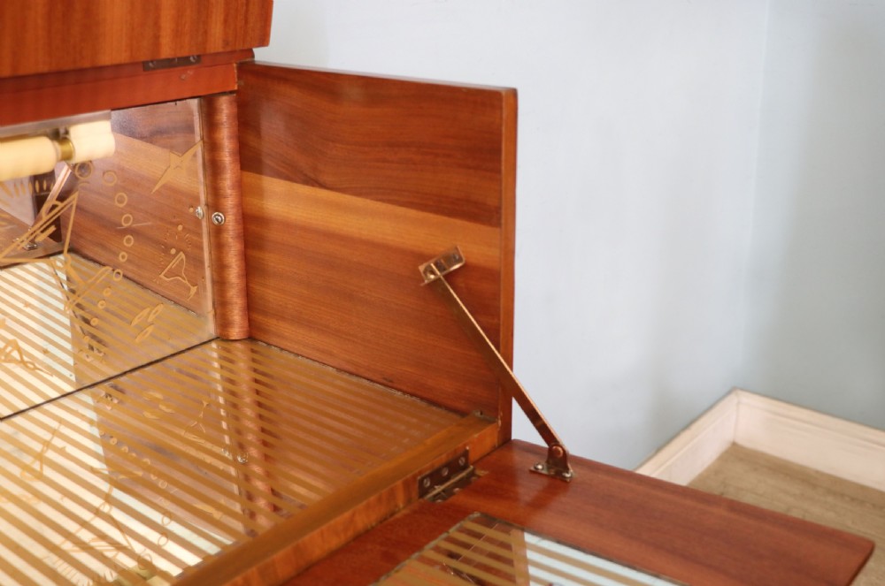 A wonderfully stylish piece of retro furniture An Art Deco walnut and chinoiserie-decorated cabinet by Rivington.  View XV
