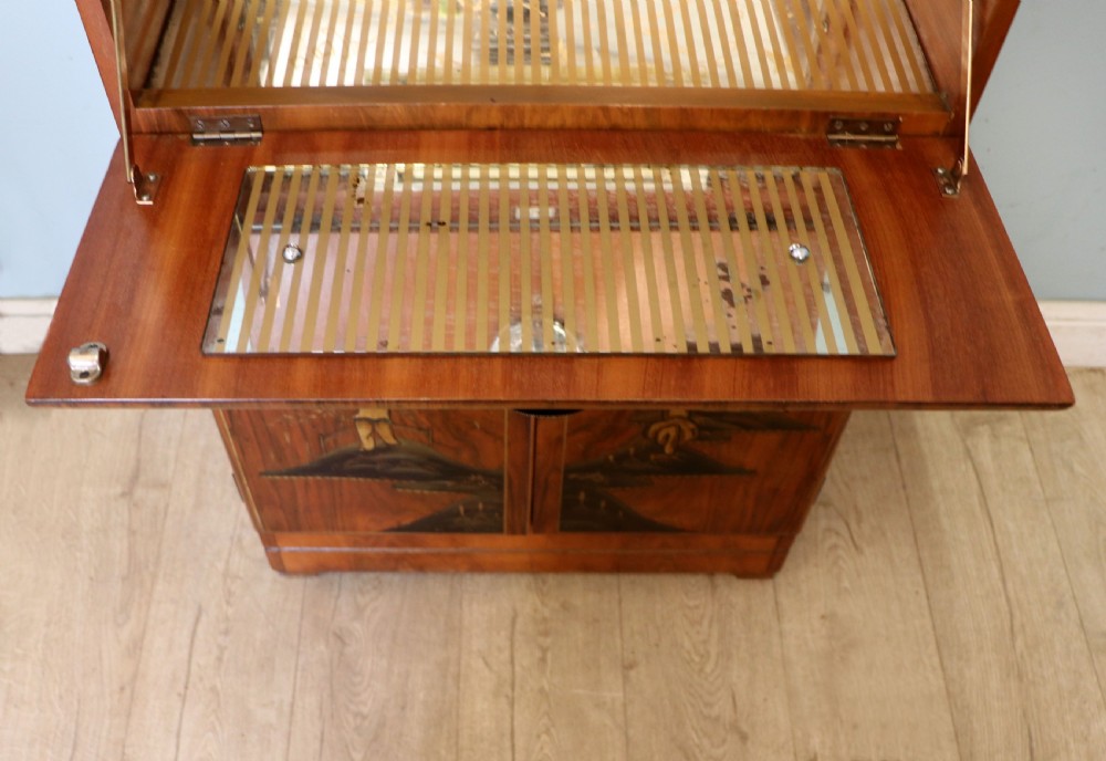 A wonderfully stylish piece of retro furniture An Art Deco walnut and chinoiserie-decorated cabinet by Rivington.  View XVI
