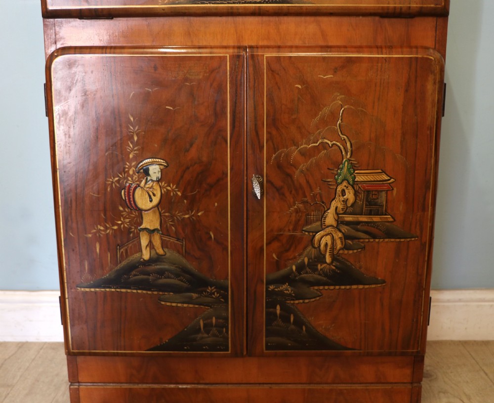 A wonderfully stylish piece of retro furniture An Art Deco walnut and chinoiserie-decorated cabinet by Rivington.  View XXI