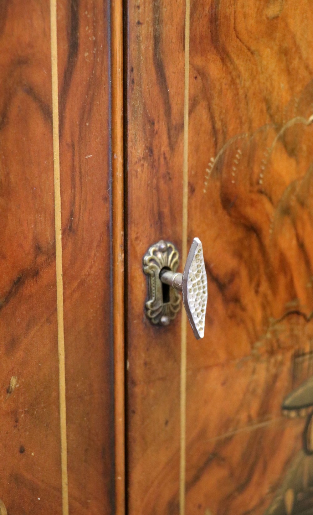 A wonderfully stylish piece of retro furniture An Art Deco walnut and chinoiserie-decorated cabinet by Rivington.  View XXV