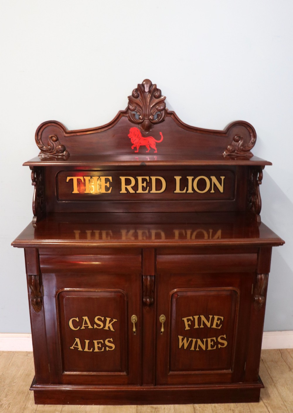 A Victorian mahogany chiffonier sideboard featuring hand-painted Red Lion pub lettering on the upper shelf back and lower cupboard doors.