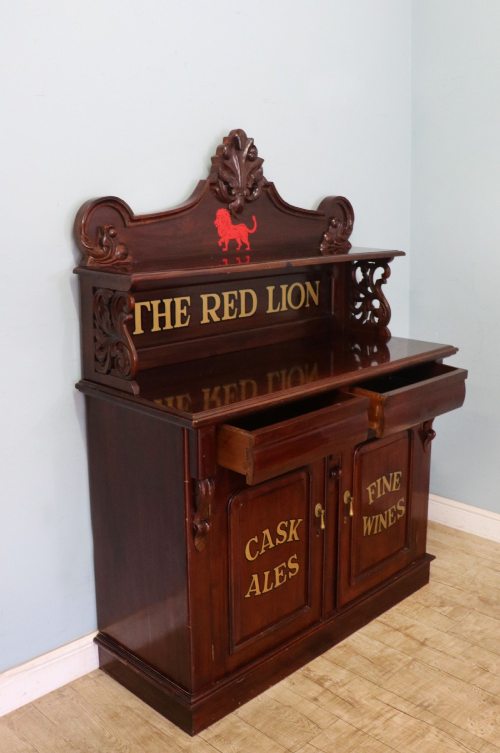 A Victorian mahogany chiffonier sideboard featuring hand-painted Red Lion pub lettering on the upper shelf back and lower cupboard doors. View V