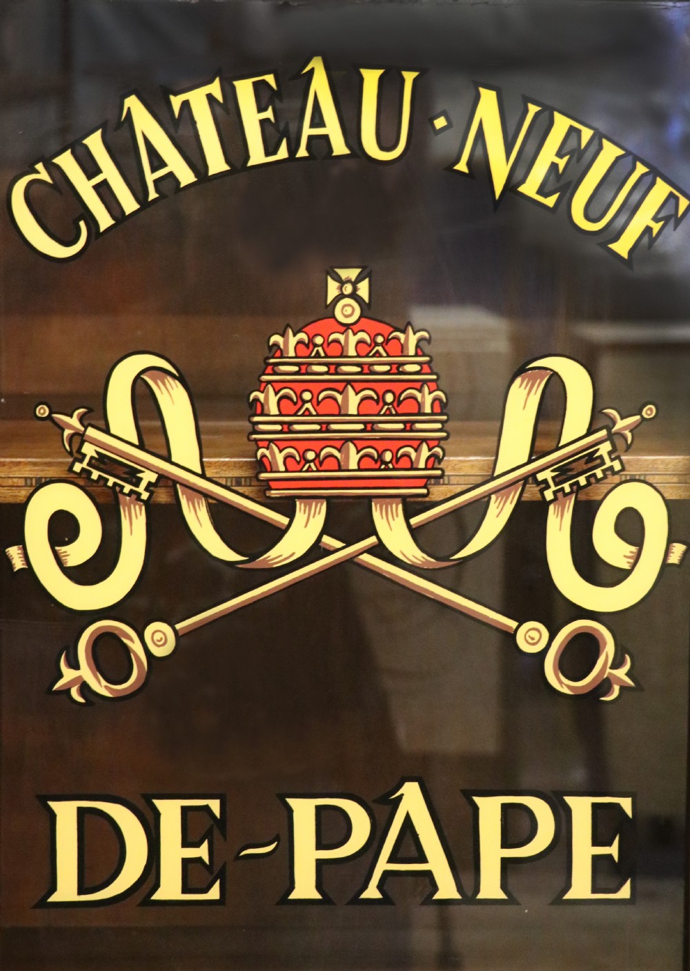 An early 20th-century French wooden display cabinet featuring a marble top, cabriole legs, gilt bronze mounts, and glass doors with hand-painted Chateauneuf-du-Pape lettering. View VI