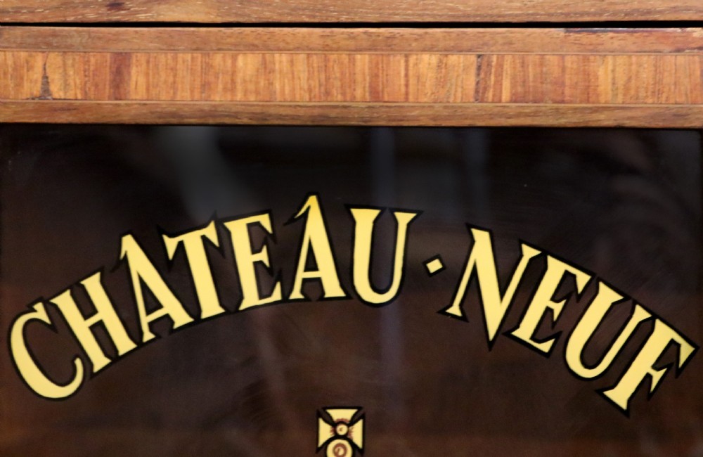 An early 20th-century French wooden display cabinet featuring a marble top, cabriole legs, gilt bronze mounts, and glass doors with hand-painted Chateauneuf-du-Pape lettering. View VIII