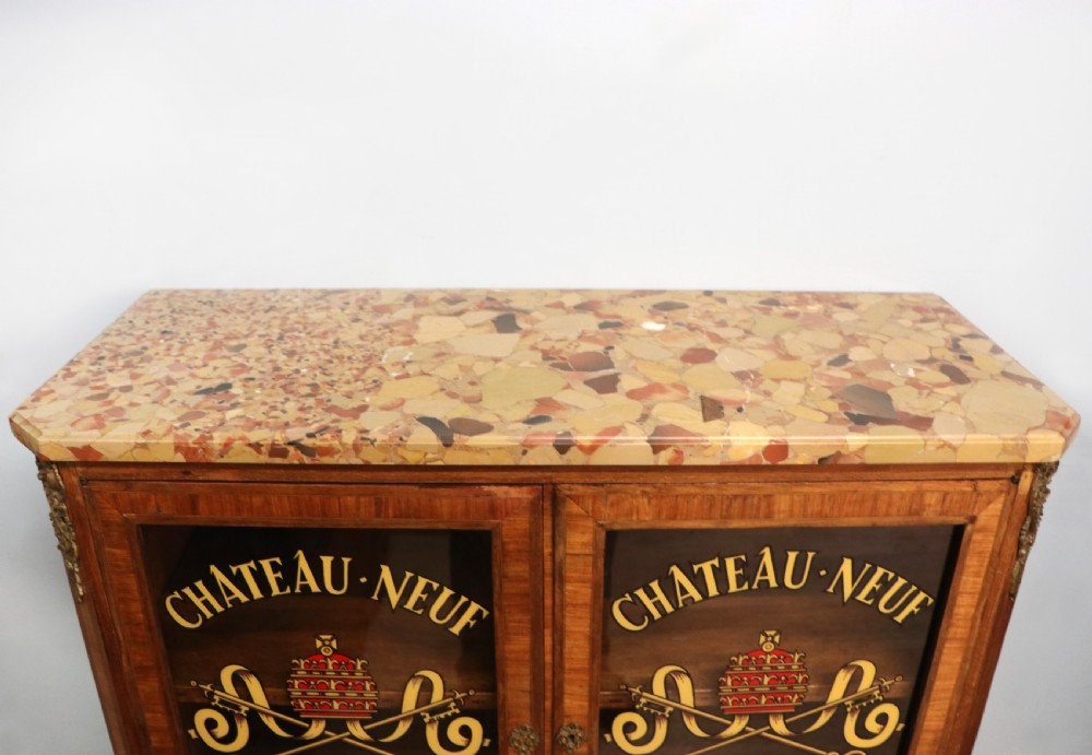 An early 20th-century French wooden display cabinet featuring a marble top, cabriole legs, gilt bronze mounts, and glass doors with hand-painted Chateauneuf-du-Pape lettering. View XI