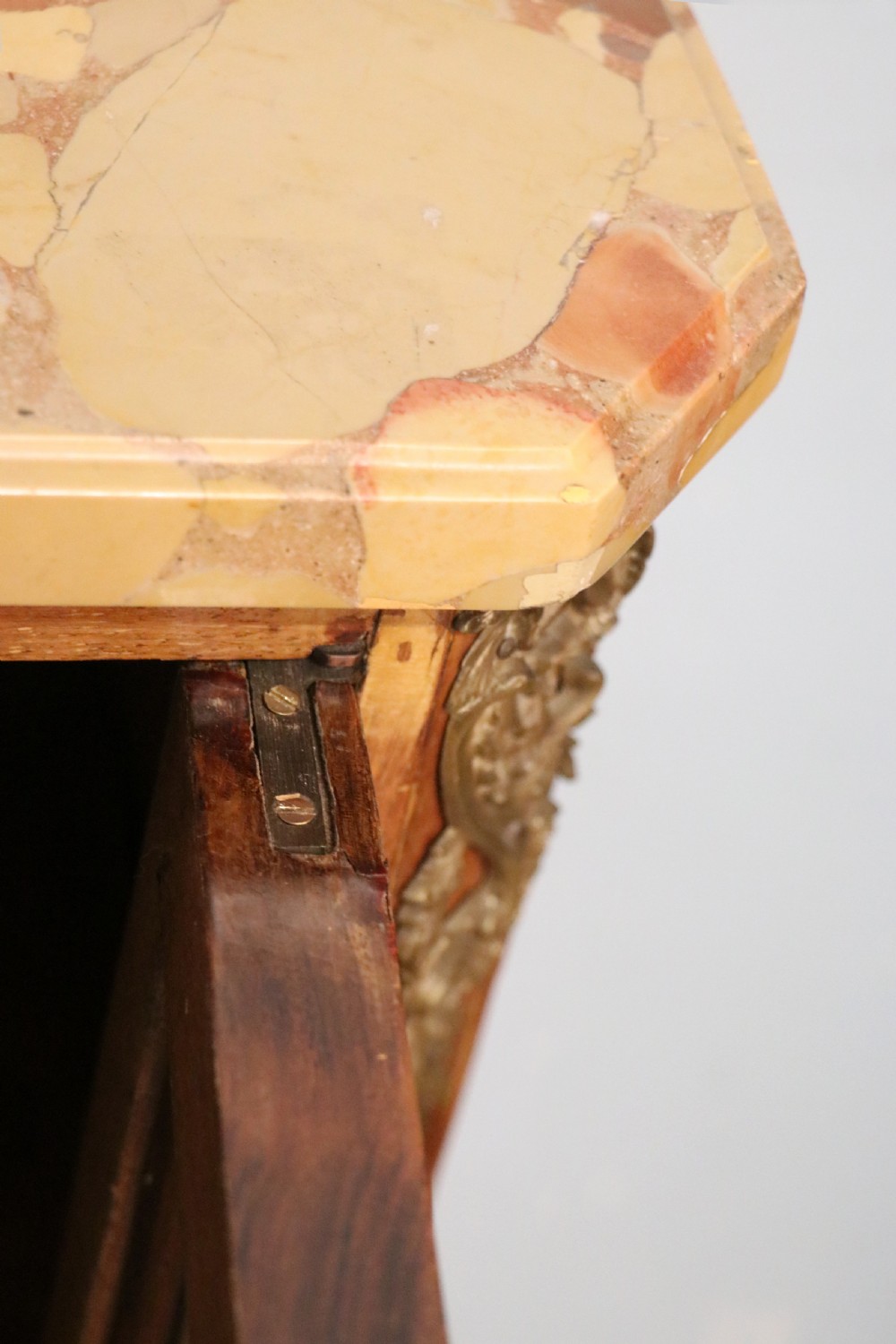 An early 20th-century French wooden display cabinet featuring a marble top, cabriole legs, gilt bronze mounts, and glass doors with hand-painted Chateauneuf-du-Pape lettering. View XV