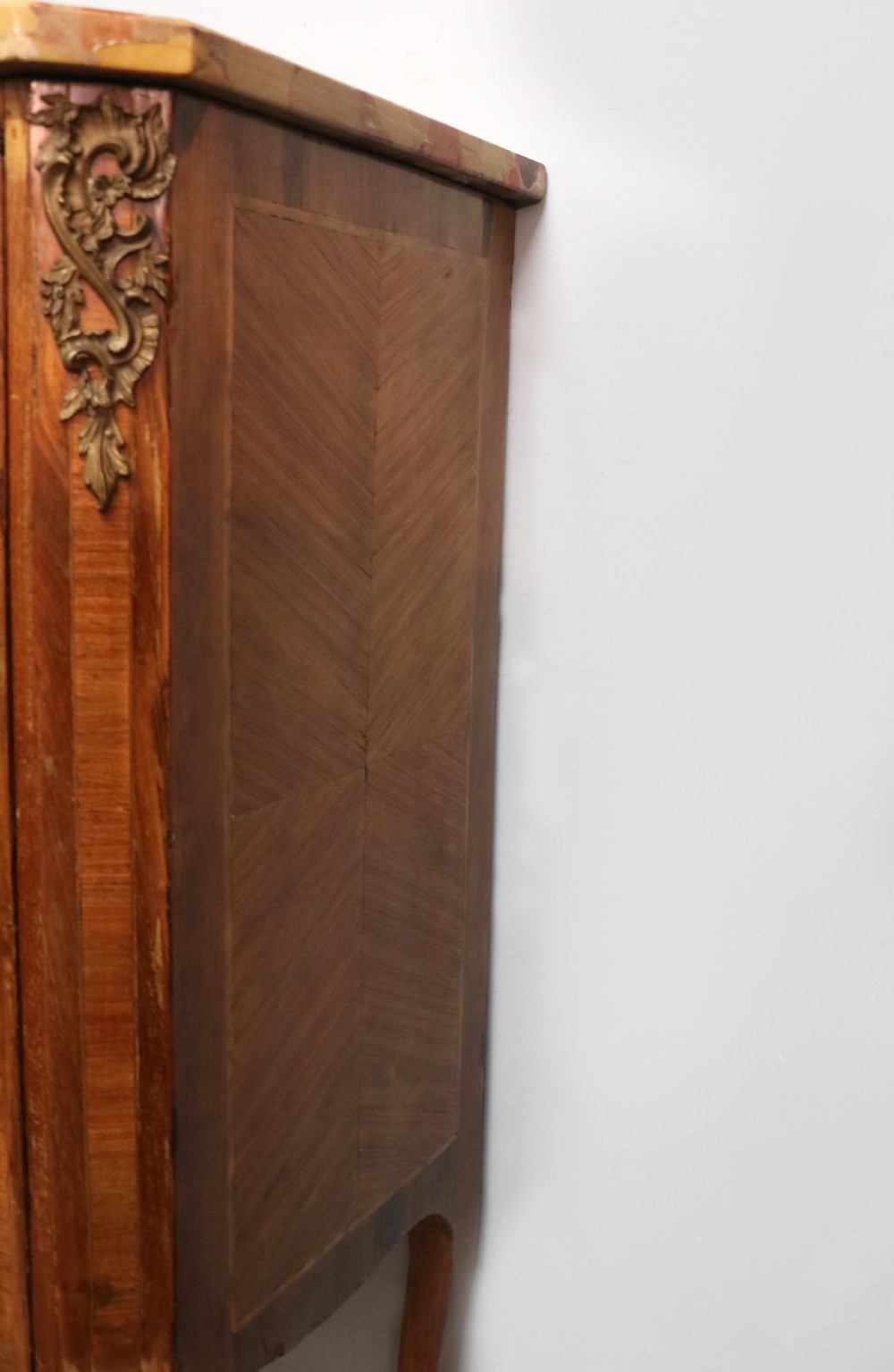 An early 20th-century French wooden display cabinet featuring a marble top, cabriole legs, gilt bronze mounts, and glass doors with hand-painted Chateauneuf-du-Pape lettering. View XX