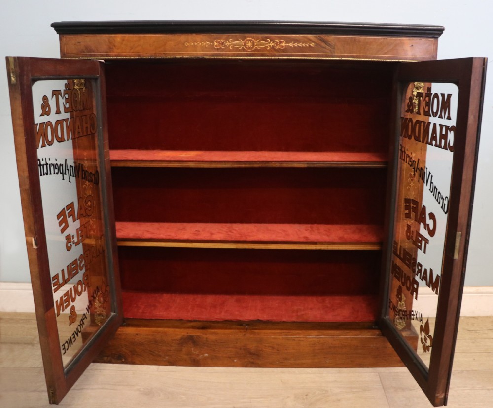 A Victorian walnut veneered and inlaid pier type display cabinet, with advertising for champagne producers Moet & Chandon. View IV