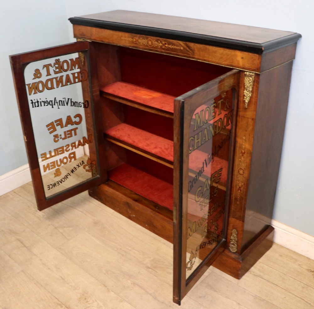 A Victorian walnut veneered and inlaid pier type display cabinet, with advertising for champagne producers Moet & Chandon. View V