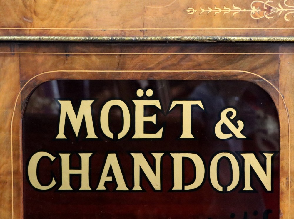 A Victorian walnut veneered and inlaid pier type display cabinet, with advertising for champagne producers Moet & Chandon. View XI