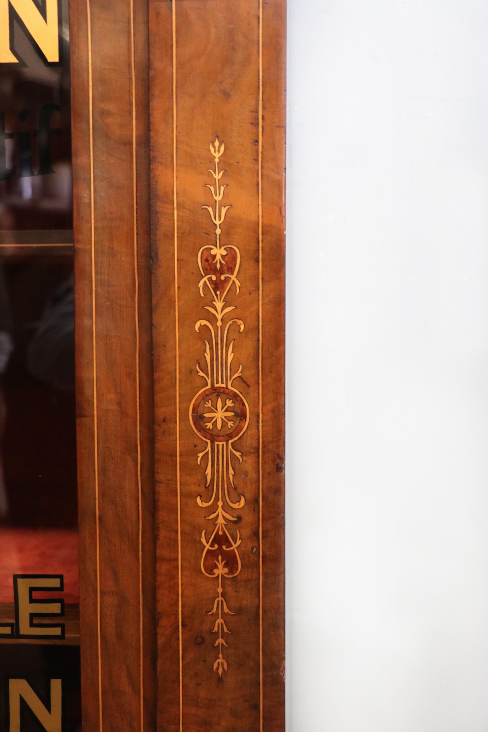 A Victorian walnut veneered and inlaid pier type display cabinet, with advertising for champagne producers Moet & Chandon. View XV