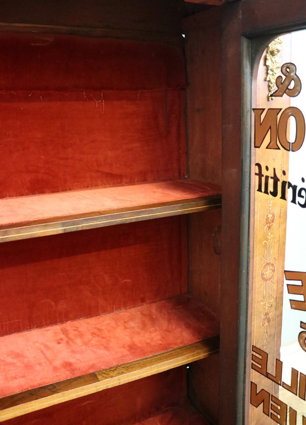 A Victorian walnut veneered and inlaid pier type display cabinet, with advertising for champagne producers Moet & Chandon. View XVIII