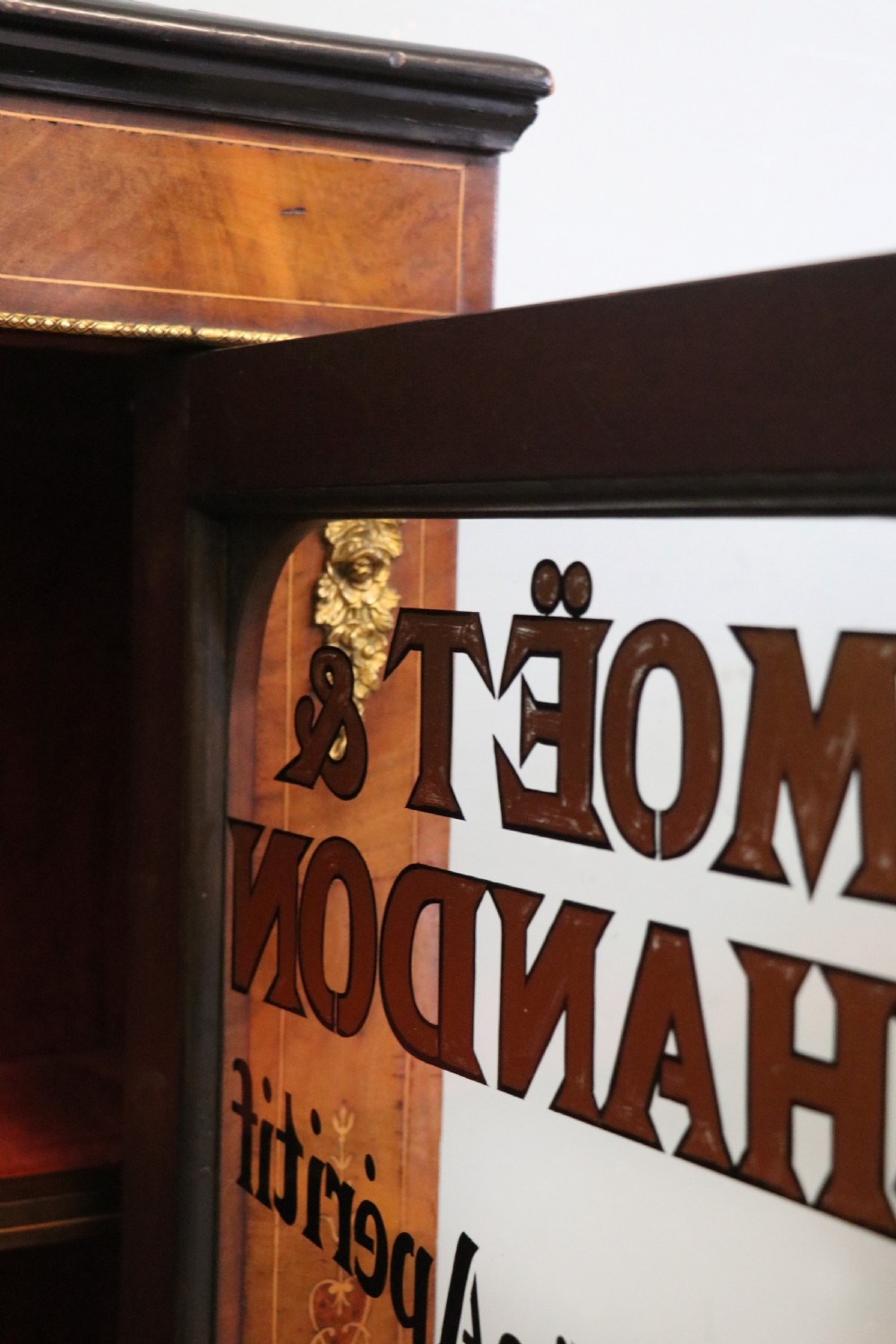 A Victorian walnut veneered and inlaid pier type display cabinet, with advertising for champagne producers Moet & Chandon. View XXIII