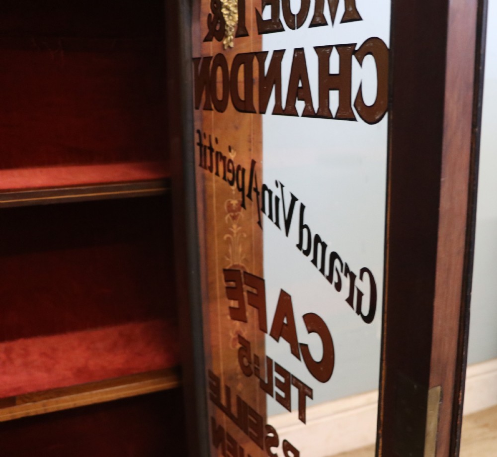 A Victorian walnut veneered and inlaid pier type display cabinet, with advertising for champagne producers Moet & Chandon. View XXIV