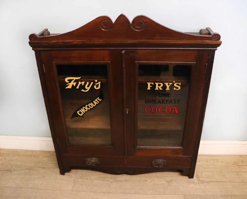 A late Victorian mahogany bookcase or display cabinet, later hand sign written for Fry’s cocoa and chocolate. 