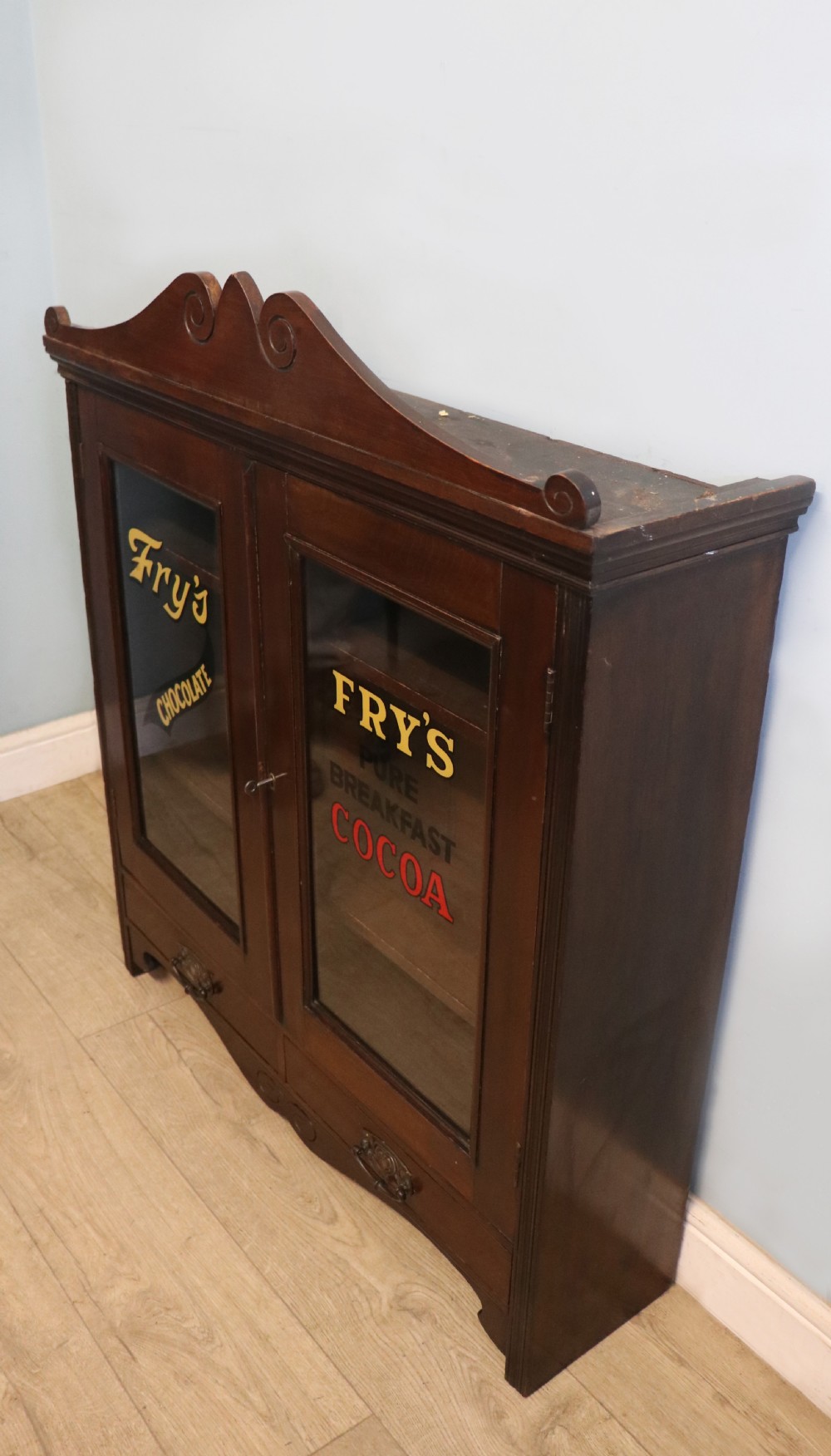 A late Victorian mahogany bookcase or display cabinet, later hand sign written for Fry’s cocoa and chocolate.  View II