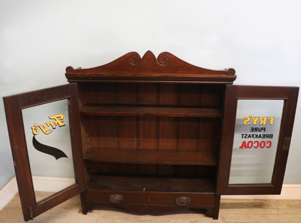 A late Victorian mahogany bookcase or display cabinet, later hand sign written for Fry’s cocoa and chocolate.  View III