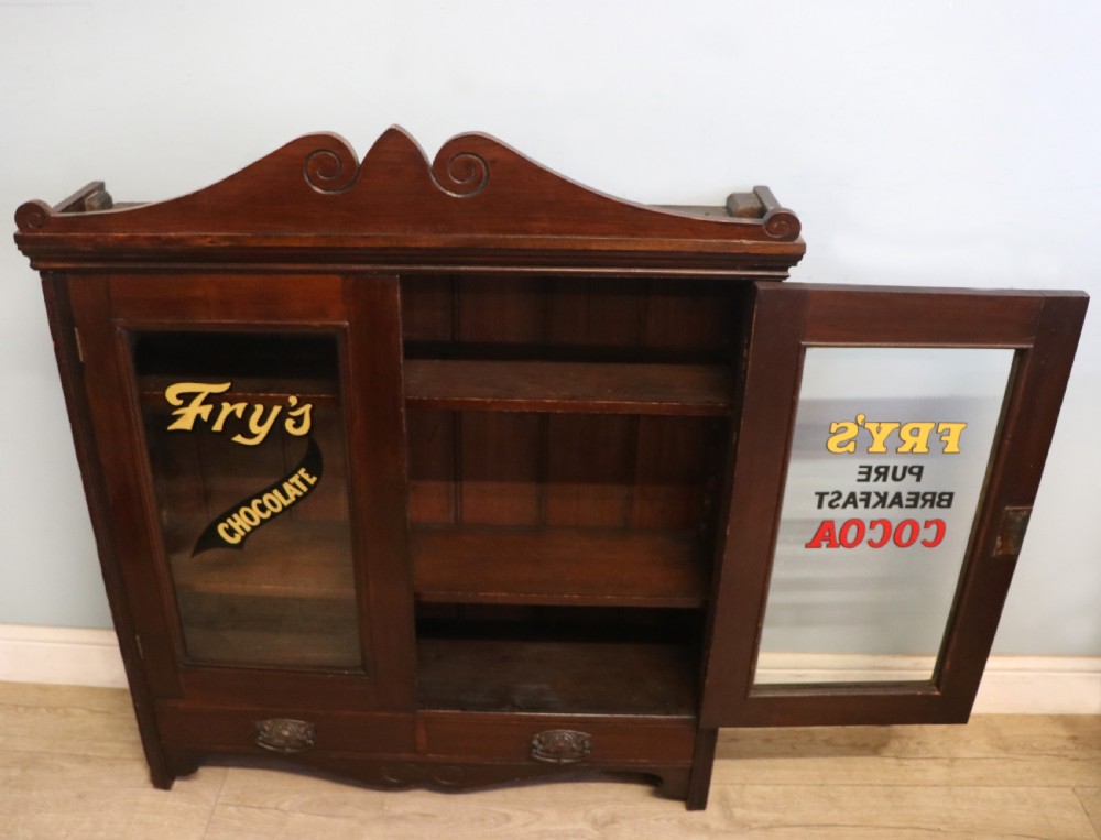 A late Victorian mahogany bookcase or display cabinet, later hand sign written for Fry’s cocoa and chocolate.  View IV