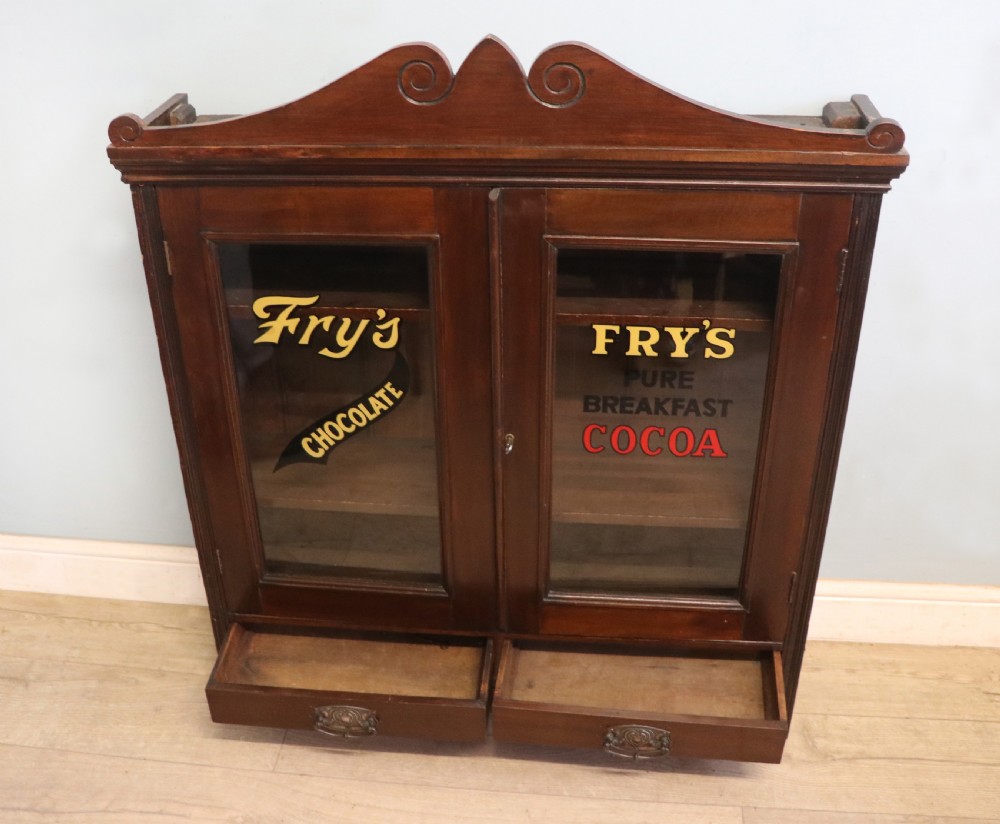 A late Victorian mahogany bookcase or display cabinet, later hand sign written for Fry’s cocoa and chocolate.  View V