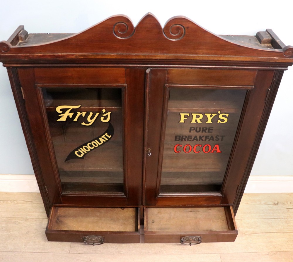 A late Victorian mahogany bookcase or display cabinet, later hand sign written for Fry’s cocoa and chocolate.  View VI