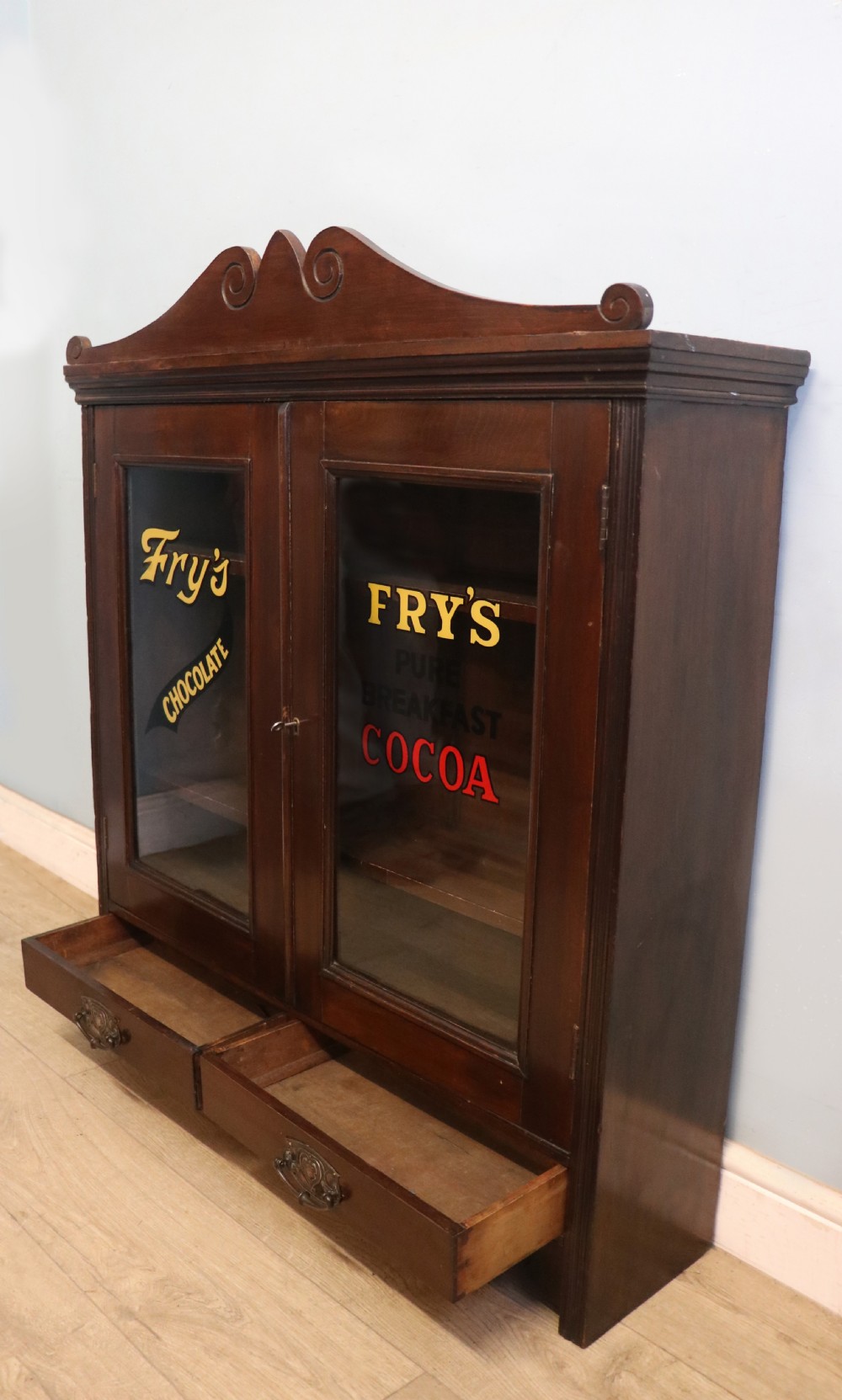 A late Victorian mahogany bookcase or display cabinet, later hand sign written for Fry’s cocoa and chocolate.  View VII