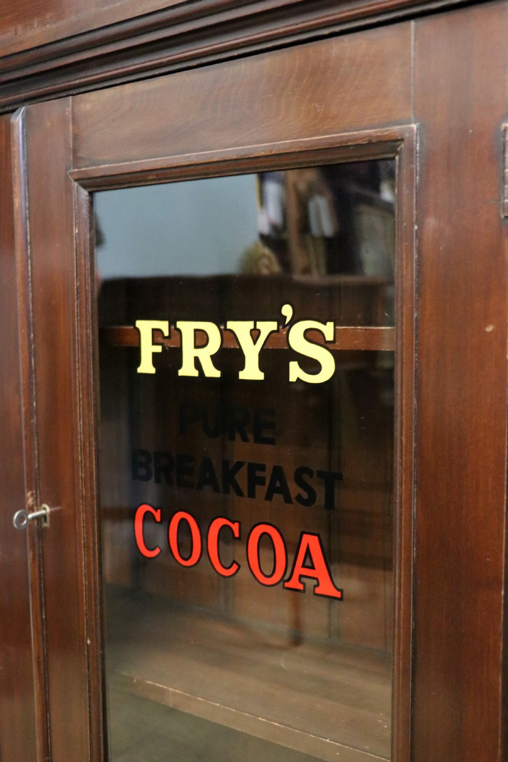 A late Victorian mahogany bookcase or display cabinet, later hand sign written for Fry’s cocoa and chocolate.  View XIV