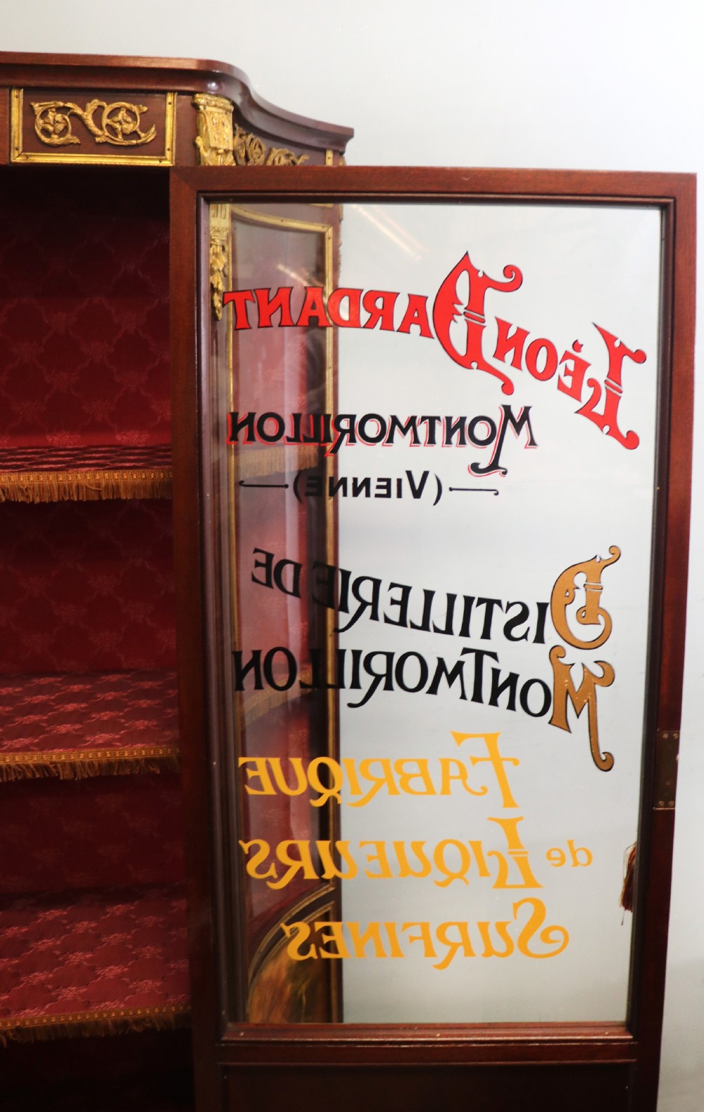 A very fine 20th century Vernis Martin style vitrine display cabinet, later sign written for Leon Dardant distillery of Vienna. View XIX