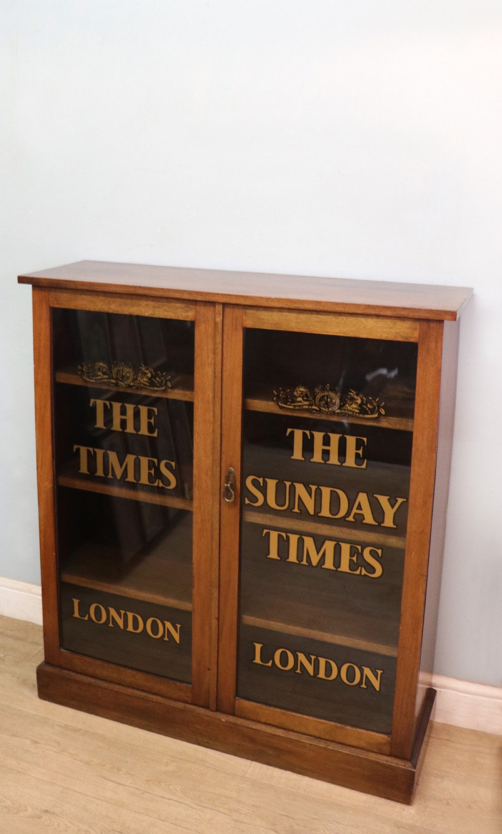 A wonderful late 19th display cabinet with sliding glass doors, later hand sign written for the Times and the Sunday Times. View III
