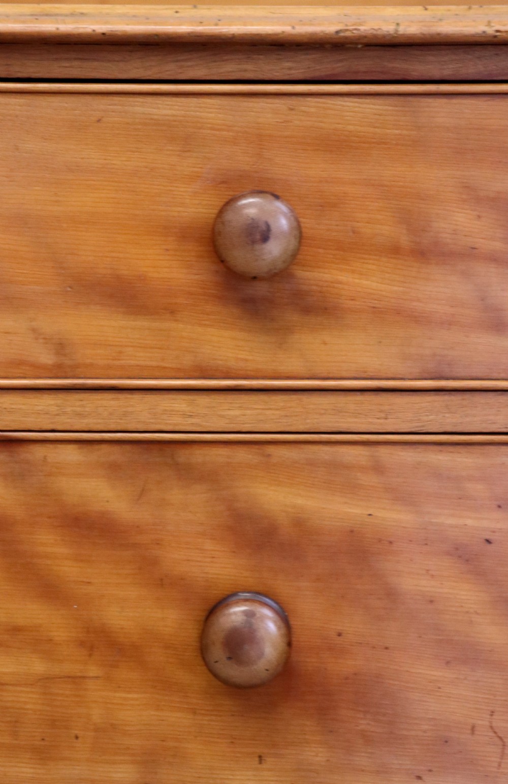 A Victorian satin birch chest of drawers featuring a shaped gallery backboard, two short over two long drawers with turned knobs, resting on a plinth base. View XVIII