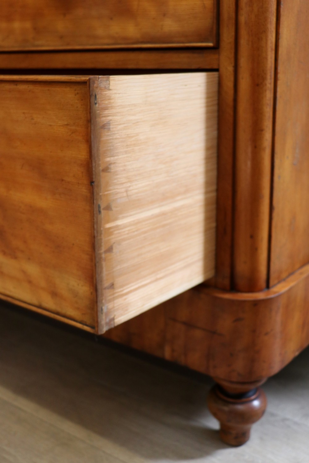 A Victorian satin birch chest of drawers featuring a shaped gallery backboard, two short over two long drawers with turned knobs, resting on a plinth base. View XXI