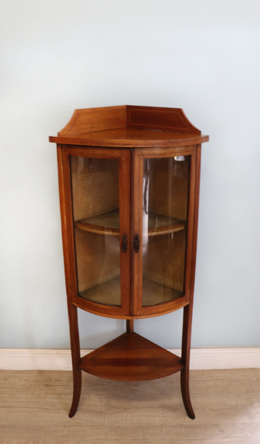  A lovely small Edwardian mahogany and inlaid corner display cabinet.  View II