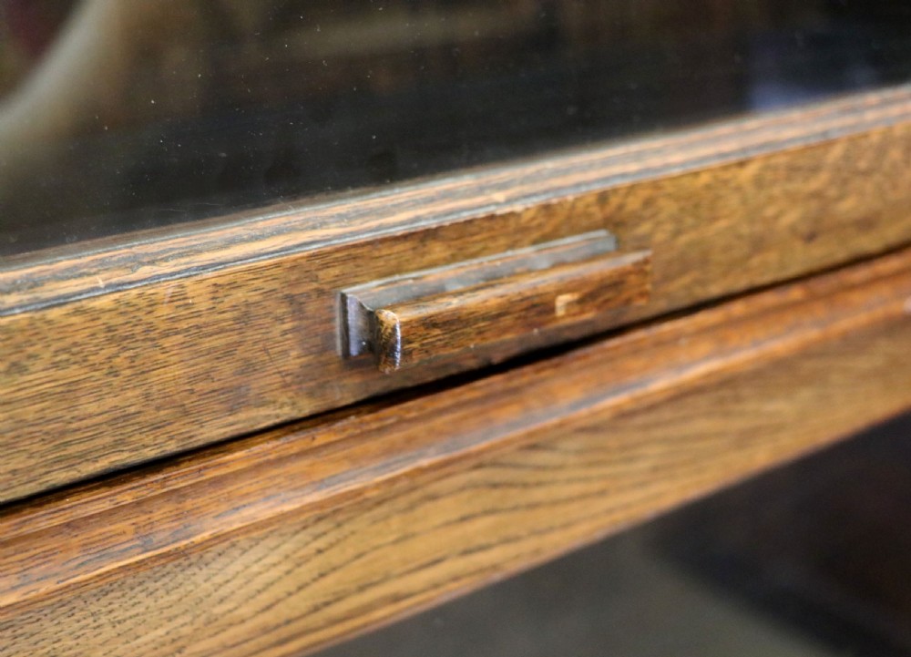 A quality barristers style bookcase dating to the early 20th century.  View X
