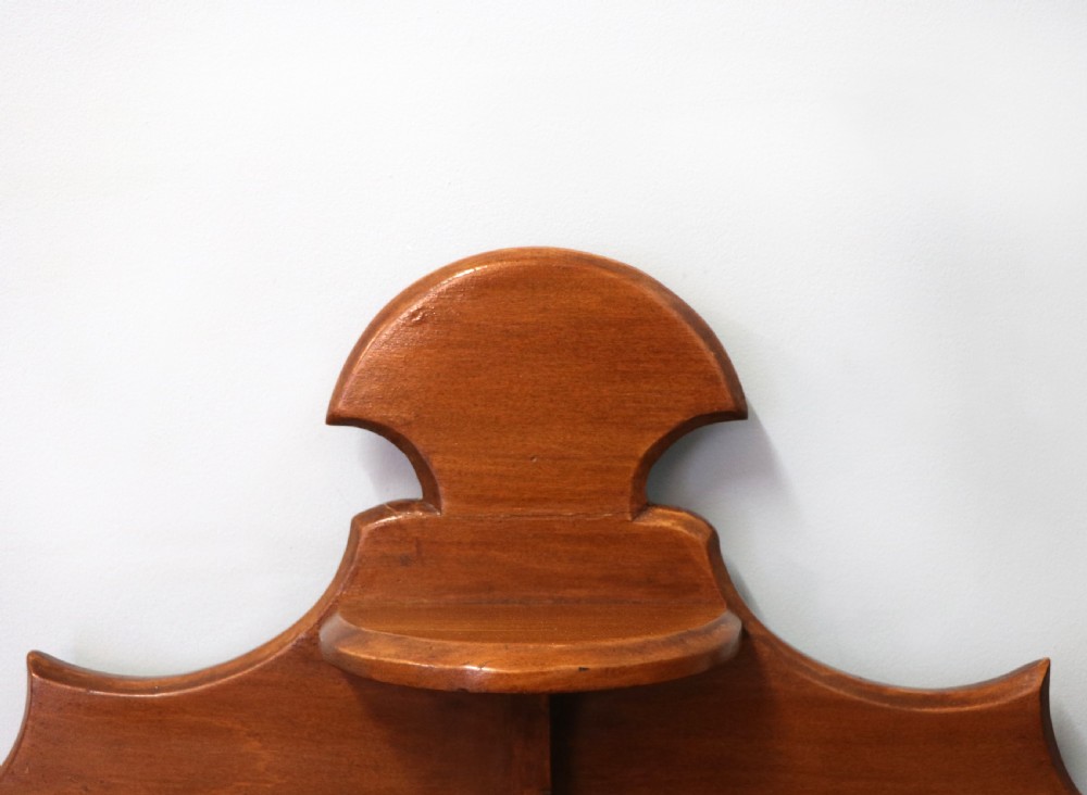 A Victorian American walnut glazed display cabinet featuring a shaped top pediment and hand-painted Frys Chocolate advertising on the single glass door. View X