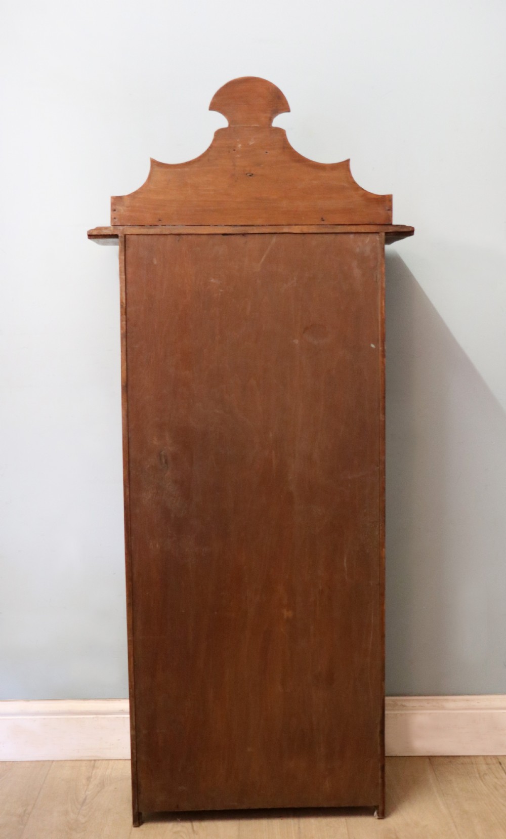 A Victorian American walnut glazed display cabinet featuring a shaped top pediment and hand-painted Frys Chocolate advertising on the single glass door. View XXVII