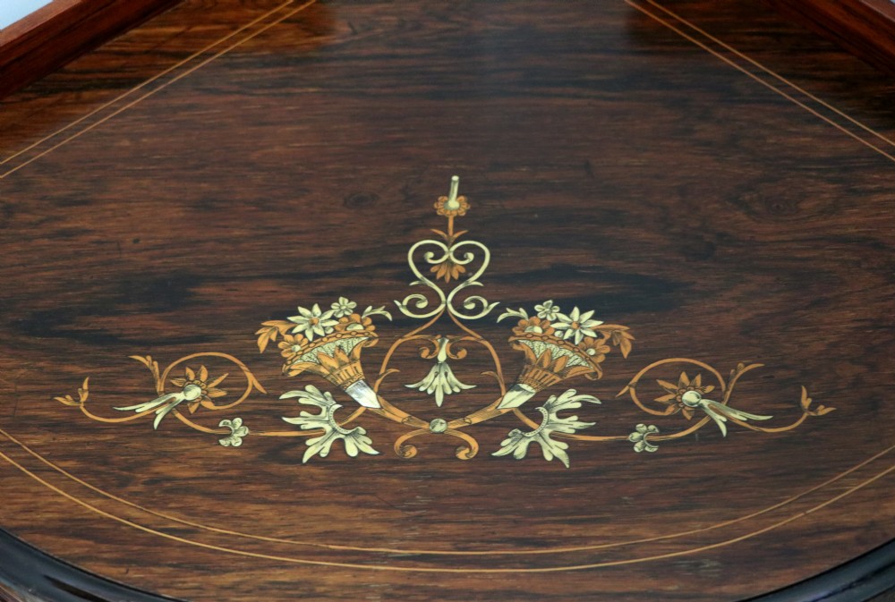 An early twentieth-century Sheraton Revival mahogany corner table featuring elaborate floral marquetry inlay, curved legs, and an undertier shelf. View VIII