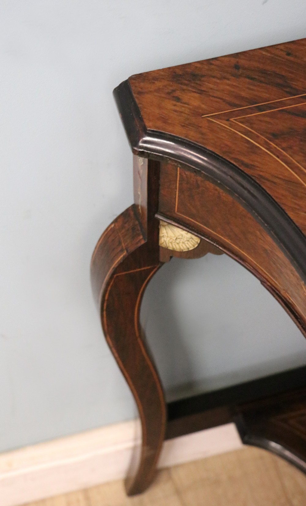 An early twentieth-century Sheraton Revival mahogany corner table featuring elaborate floral marquetry inlay, curved legs, and an undertier shelf. View IX